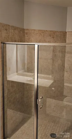 a bathroom with a glass shower door