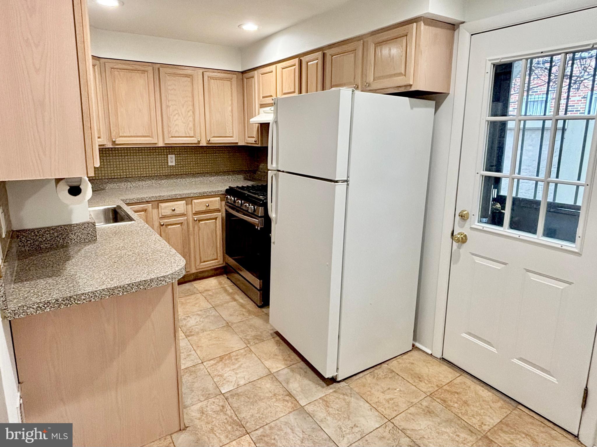 766 Martin Street Philadelphia, PA 19146 - Photo 12 of 35 a kitchen with stainless steel appliances granite countertop a refrigerator and a stove