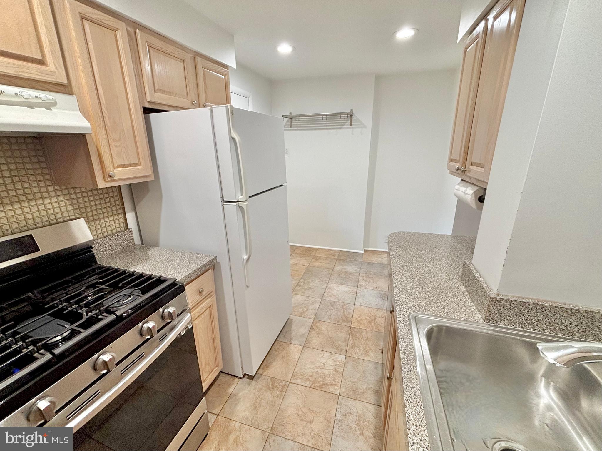 766 Martin Street Philadelphia, PA 19146 - Photo 14 of 35 a kitchen with stainless steel appliances a refrigerator and a stove
