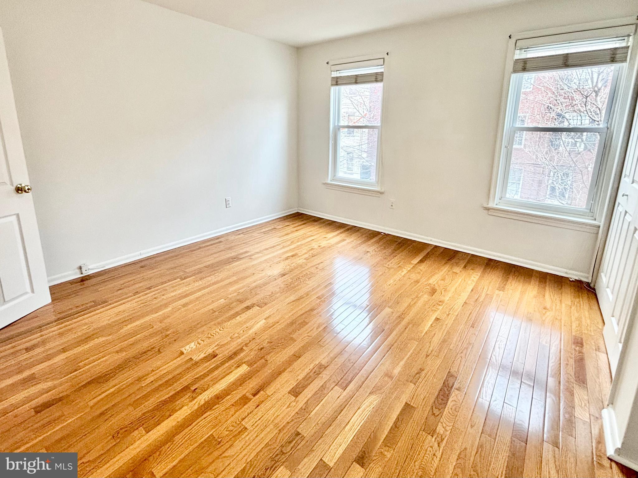 766 Martin Street Philadelphia, PA 19146 - Photo 21 of 35 an empty room with wooden floor and windows