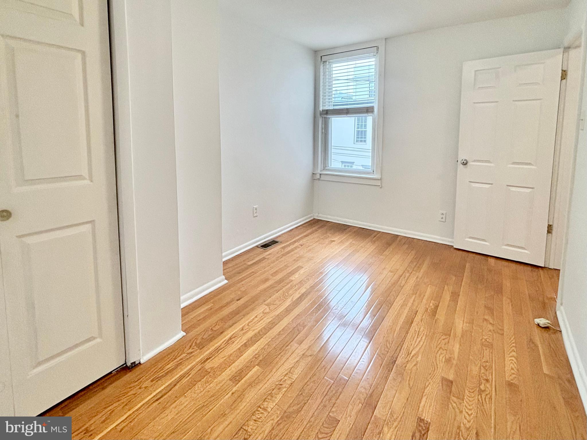 766 Martin Street Philadelphia, PA 19146 - Photo 23 of 35 an empty room with wooden floor and windows