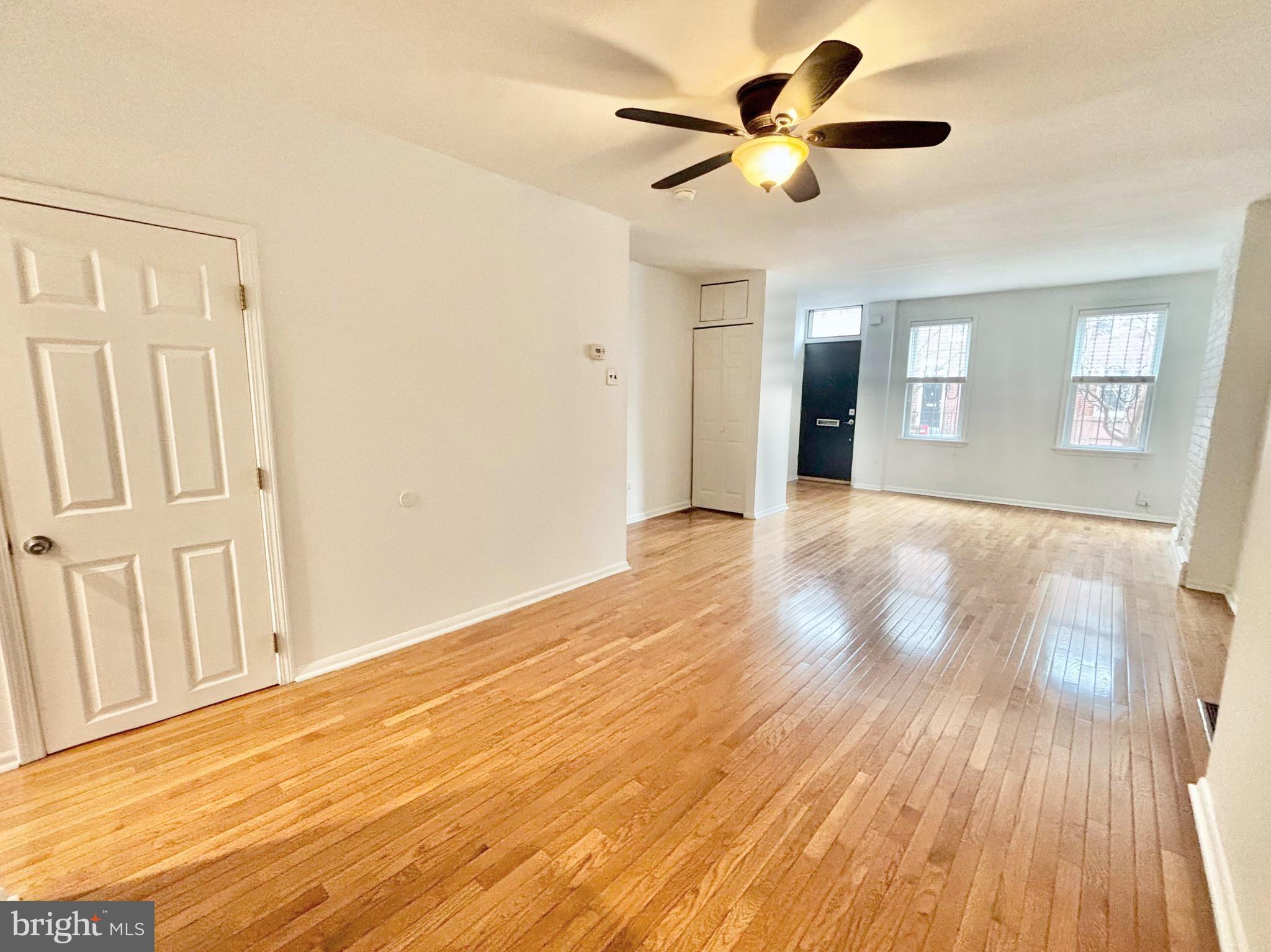 766 Martin Street Philadelphia, PA 19146 - Photo 5 of 35 a view of an empty room with window and wooden floor