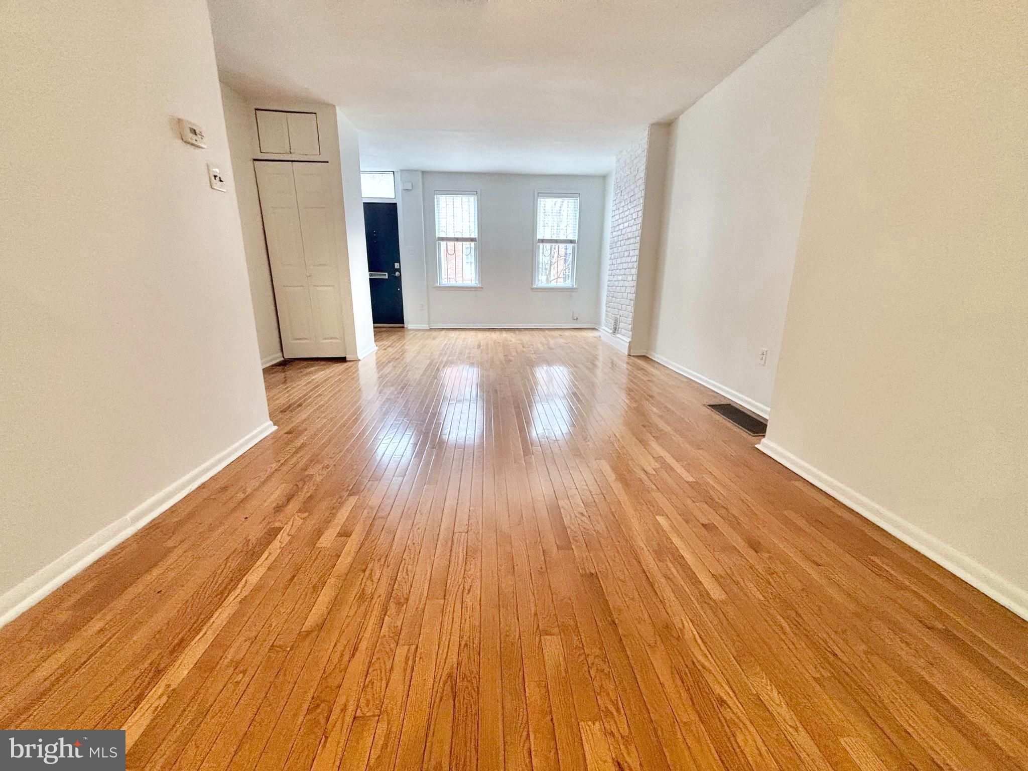 766 Martin Street Philadelphia, PA 19146 - Photo 6 of 35 an empty room with wooden floor and windows