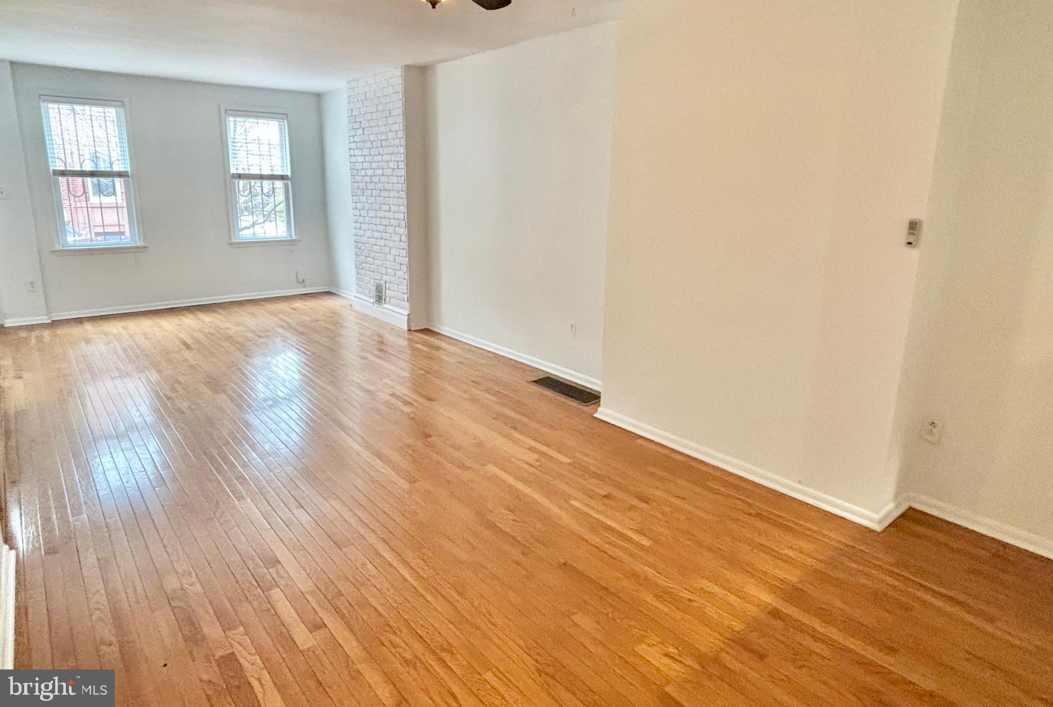 766 Martin Street Philadelphia, PA 19146 - Photo 7 of 35 an empty room with wooden floor and windows