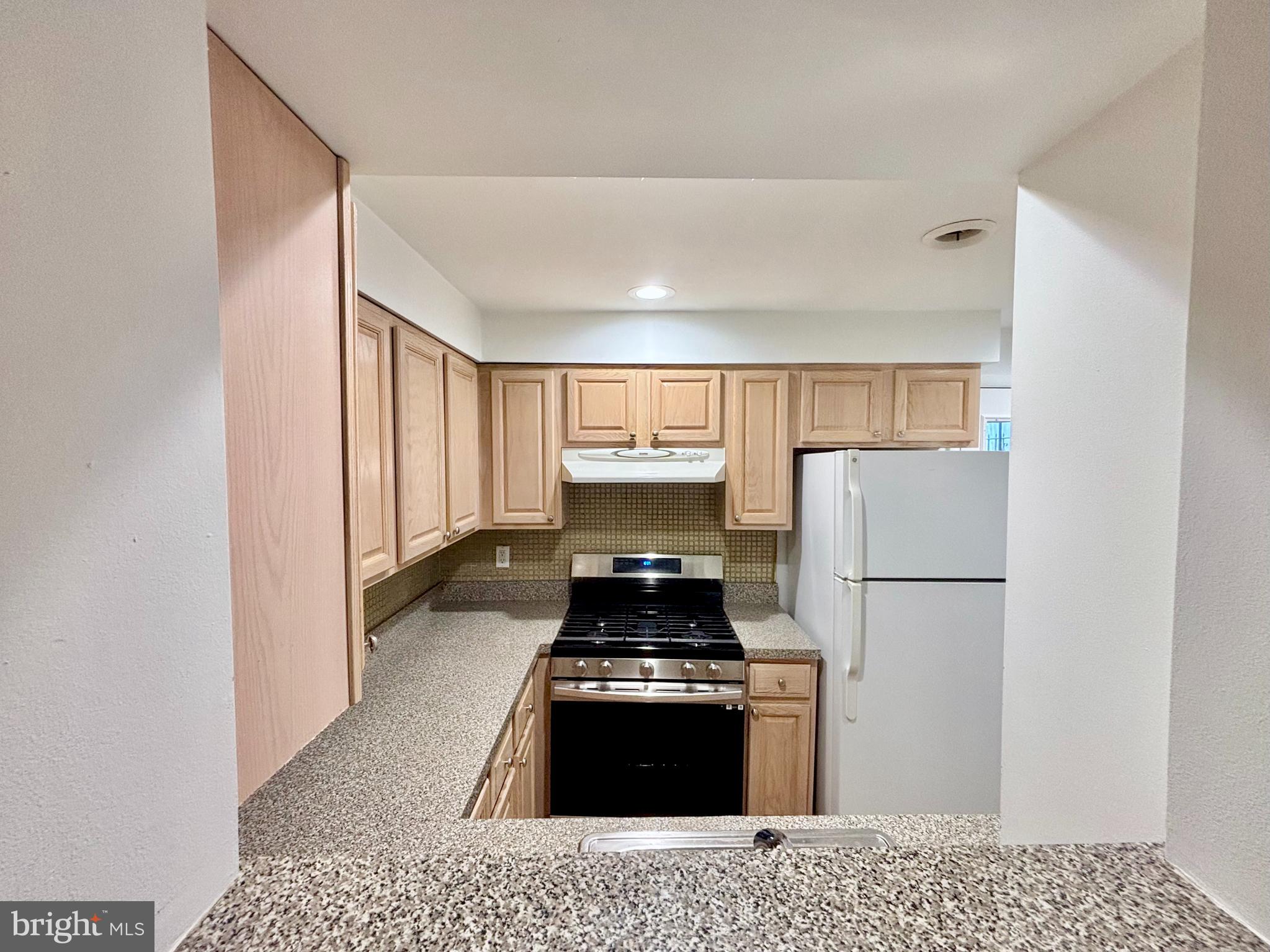 766 Martin Street Philadelphia, PA 19146 - Photo 9 of 35 a kitchen with a refrigerator and a stove