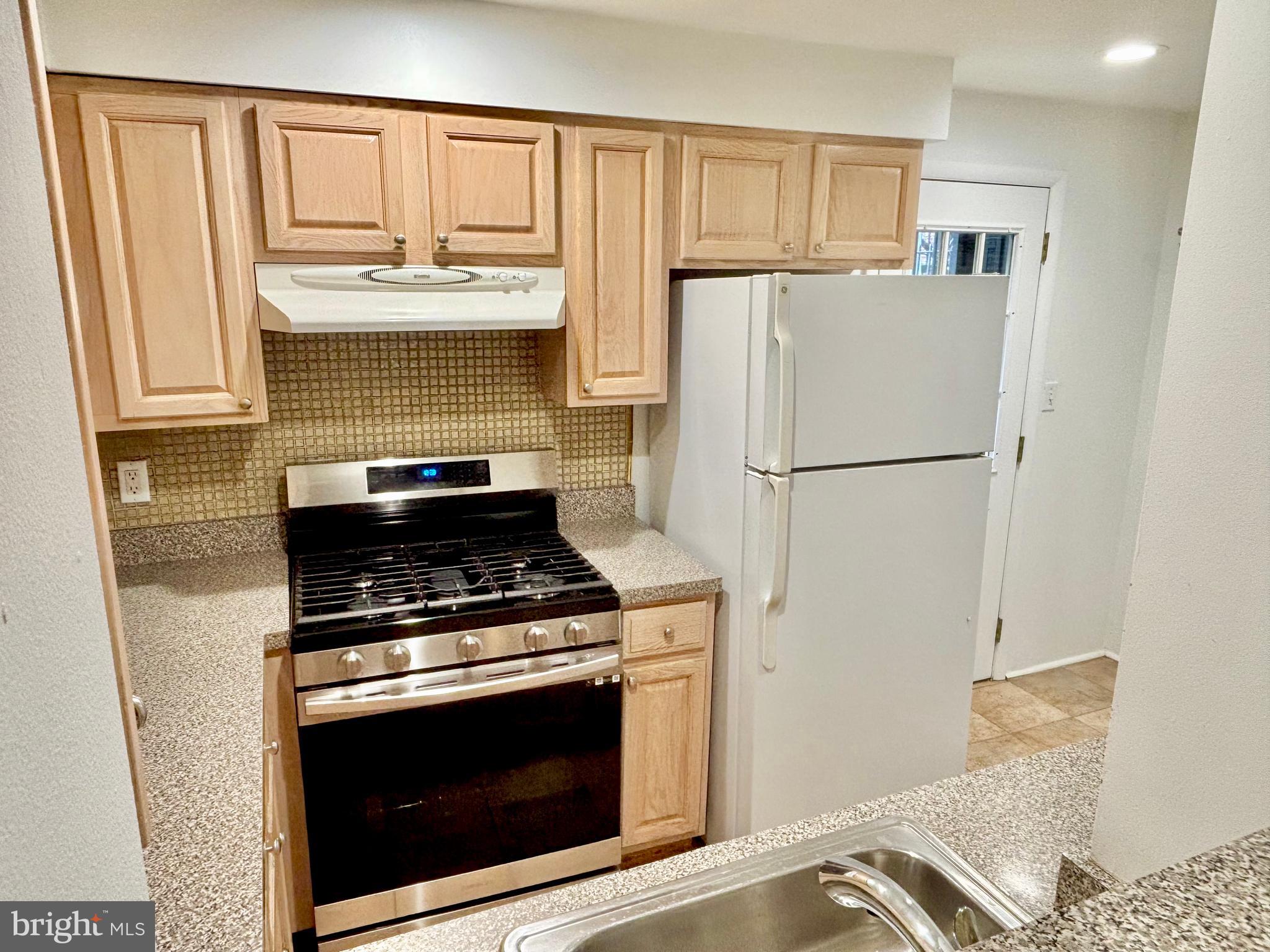 766 Martin Street Philadelphia, PA 19146 - Photo 10 of 35 a kitchen with a stove and a refrigerator