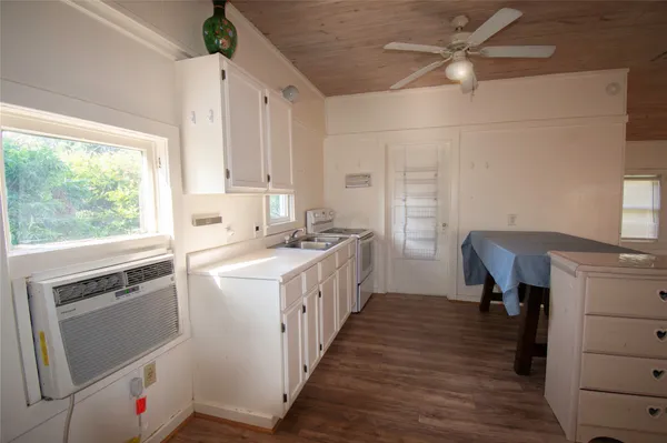 a kitchen with kitchen island a stove a sink and a refrigerator