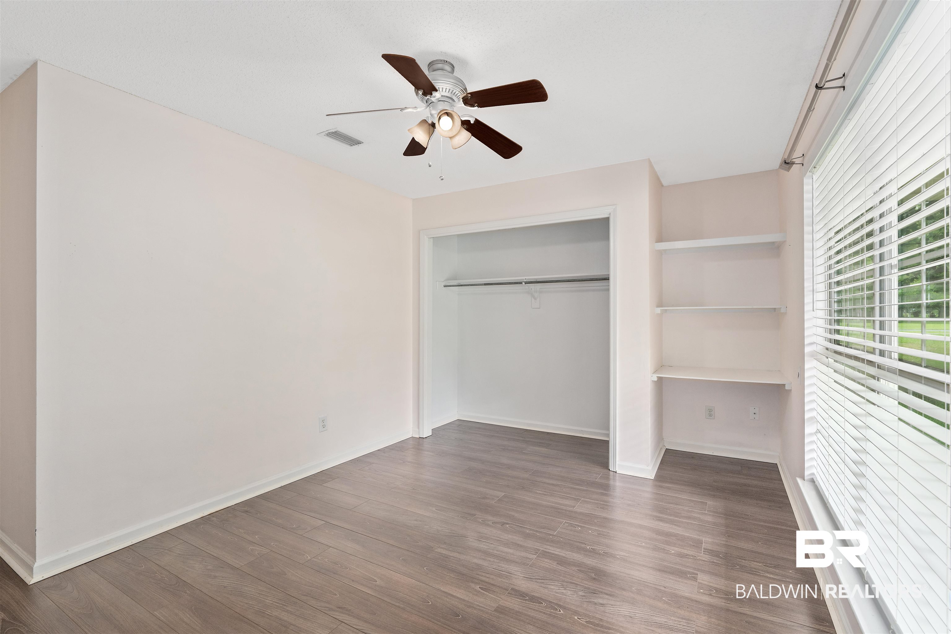 25779 Austin Road Daphne, AL 36526 - Photo 30 of 30 Unfurnished bedroom with dark wood-type flooring, baseboards, a closet, and ceiling fan