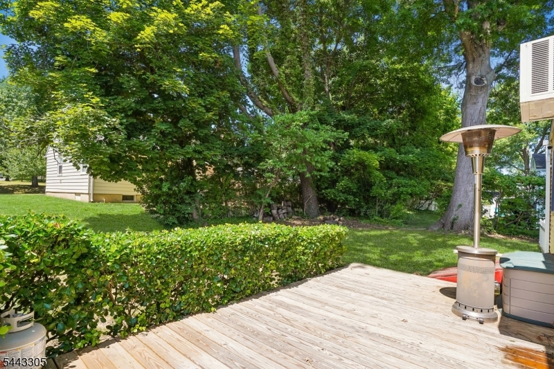 267 Kings Road Madison, NJ 07940 - Photo 23 of 37 a wooden bench sitting in middle of the middle of a yard