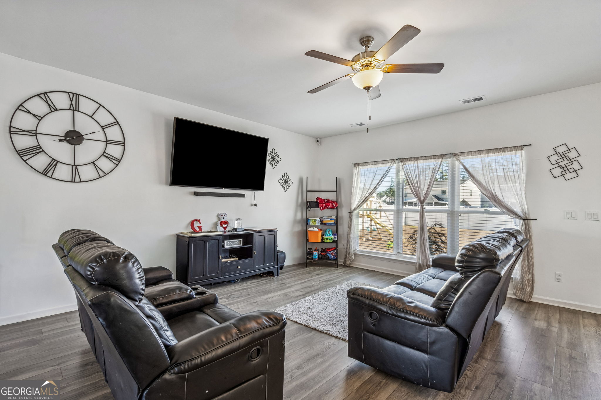 103 Olson Way Kingsland, GA 31548 - Photo 14 of 54 a living room with furniture a flat screen tv and a large window