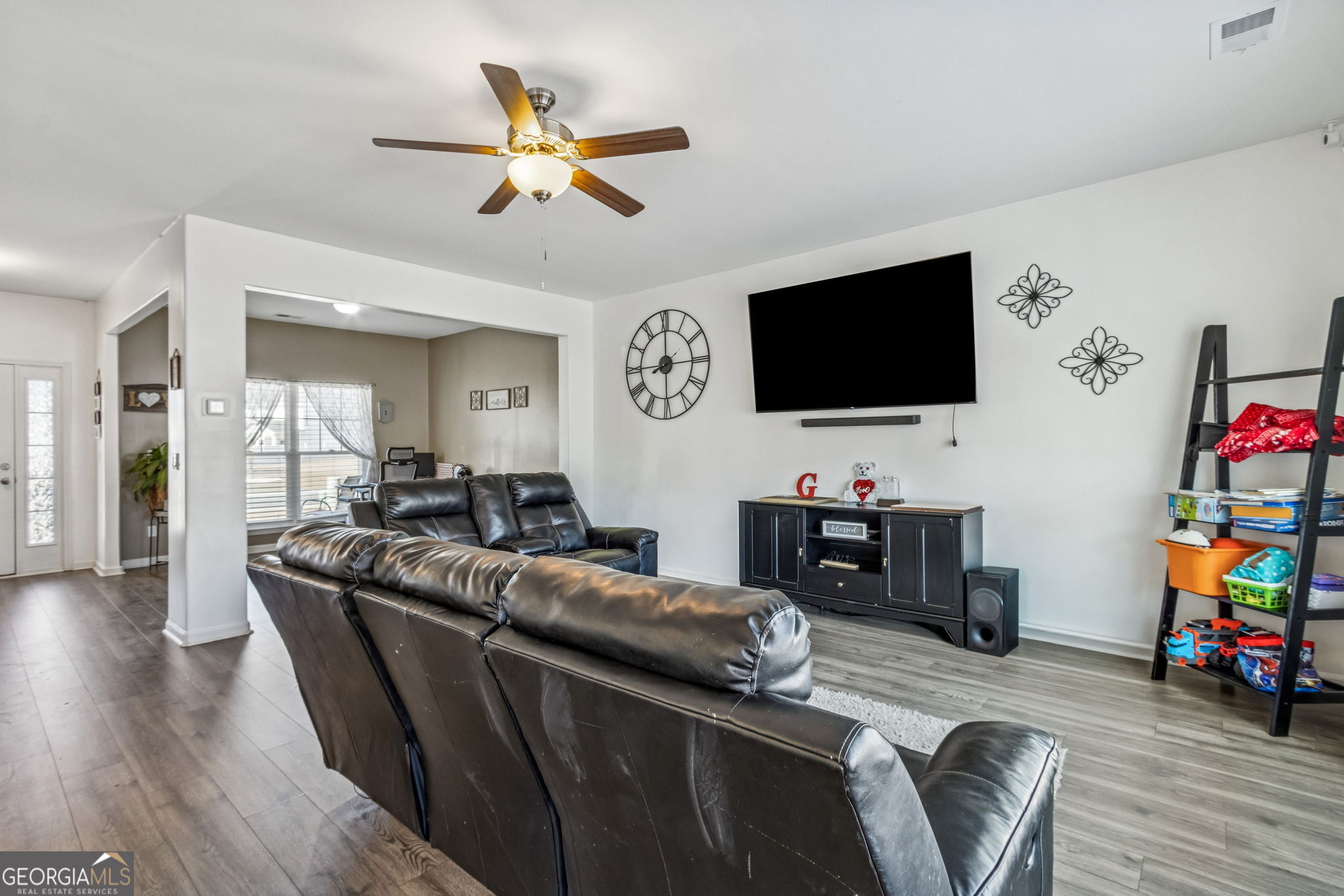 103 Olson Way Kingsland, GA 31548 - Photo 15 of 54 a living room with furniture and a flat screen tv with wooden floor