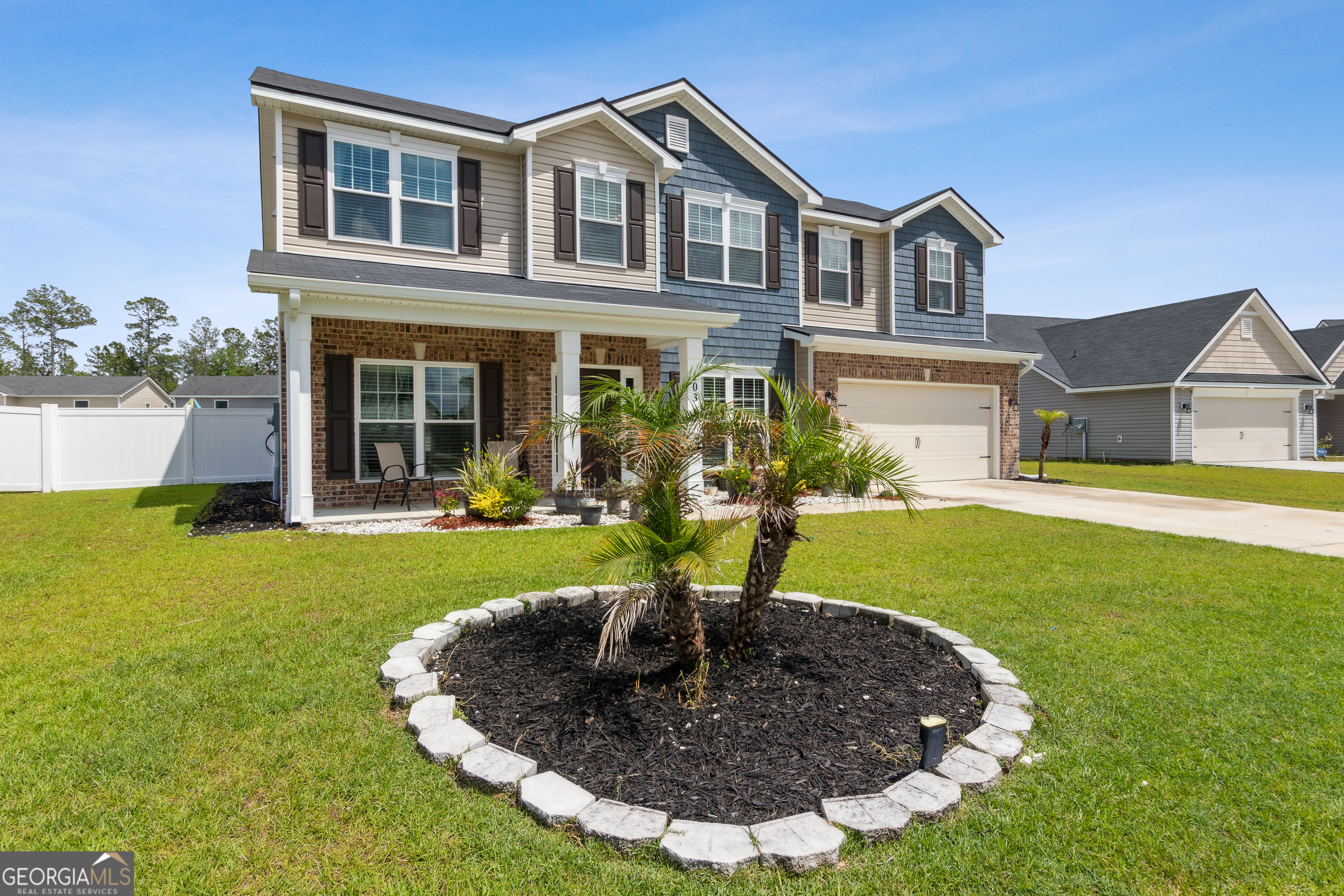 103 Olson Way Kingsland, GA 31548 - Photo 2 of 54 a front view of a house with garden