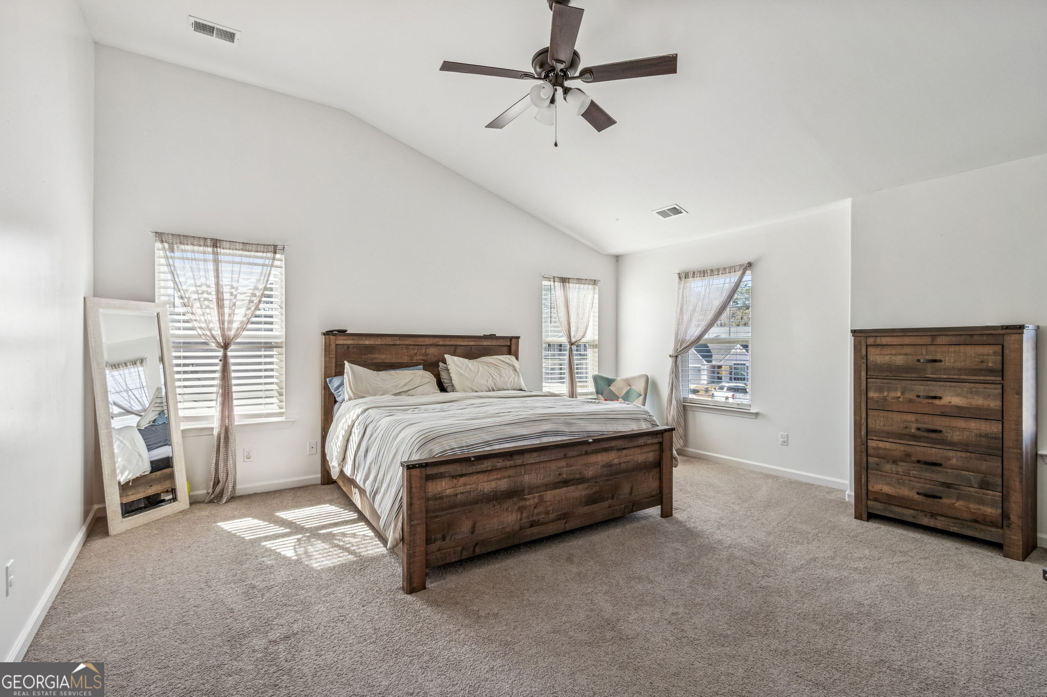 103 Olson Way Kingsland, GA 31548 - Photo 31 of 54 a spacious bedroom with a bed and a cabinets