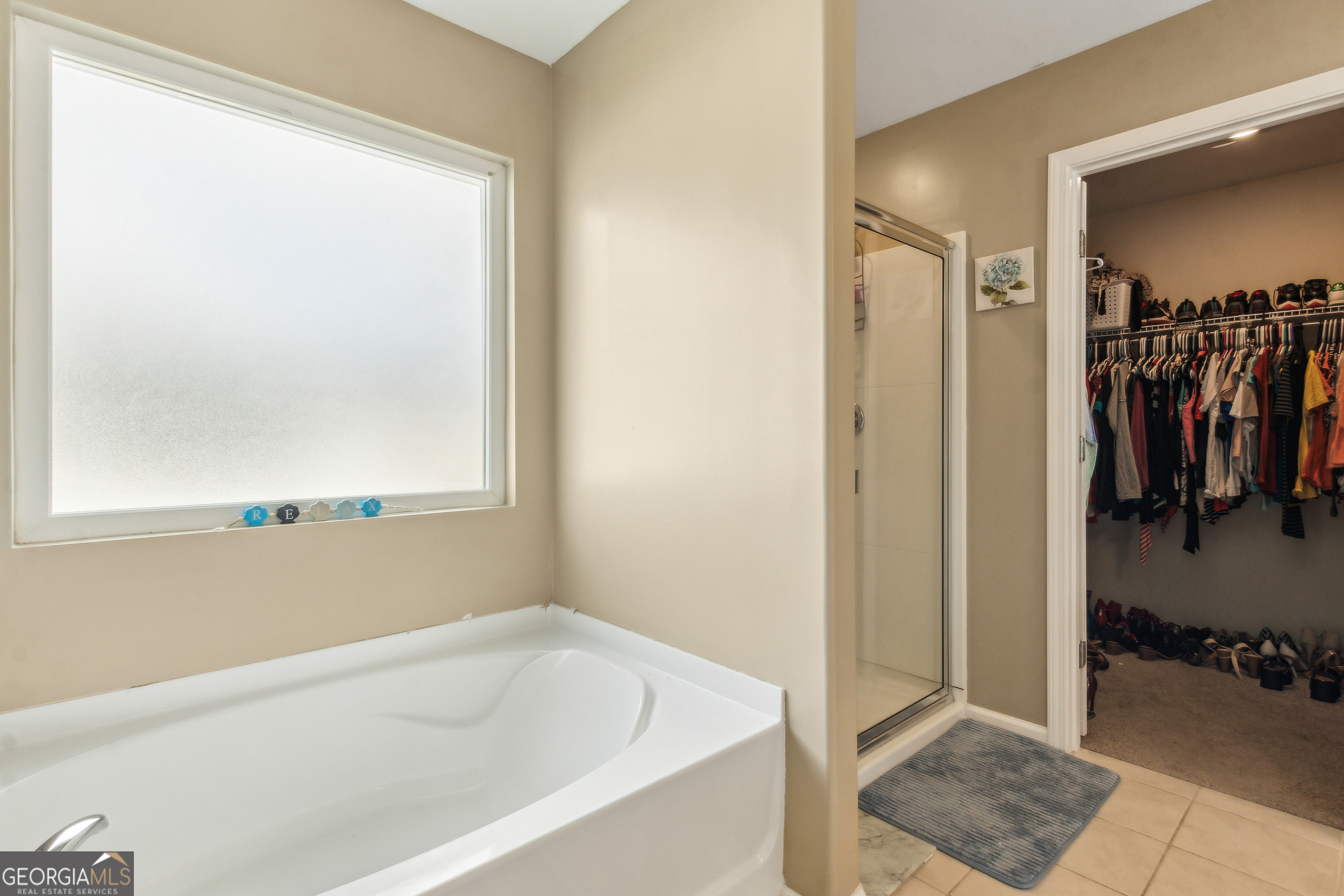 103 Olson Way Kingsland, GA 31548 - Photo 37 of 54 a bathroom with a bathtub and a window