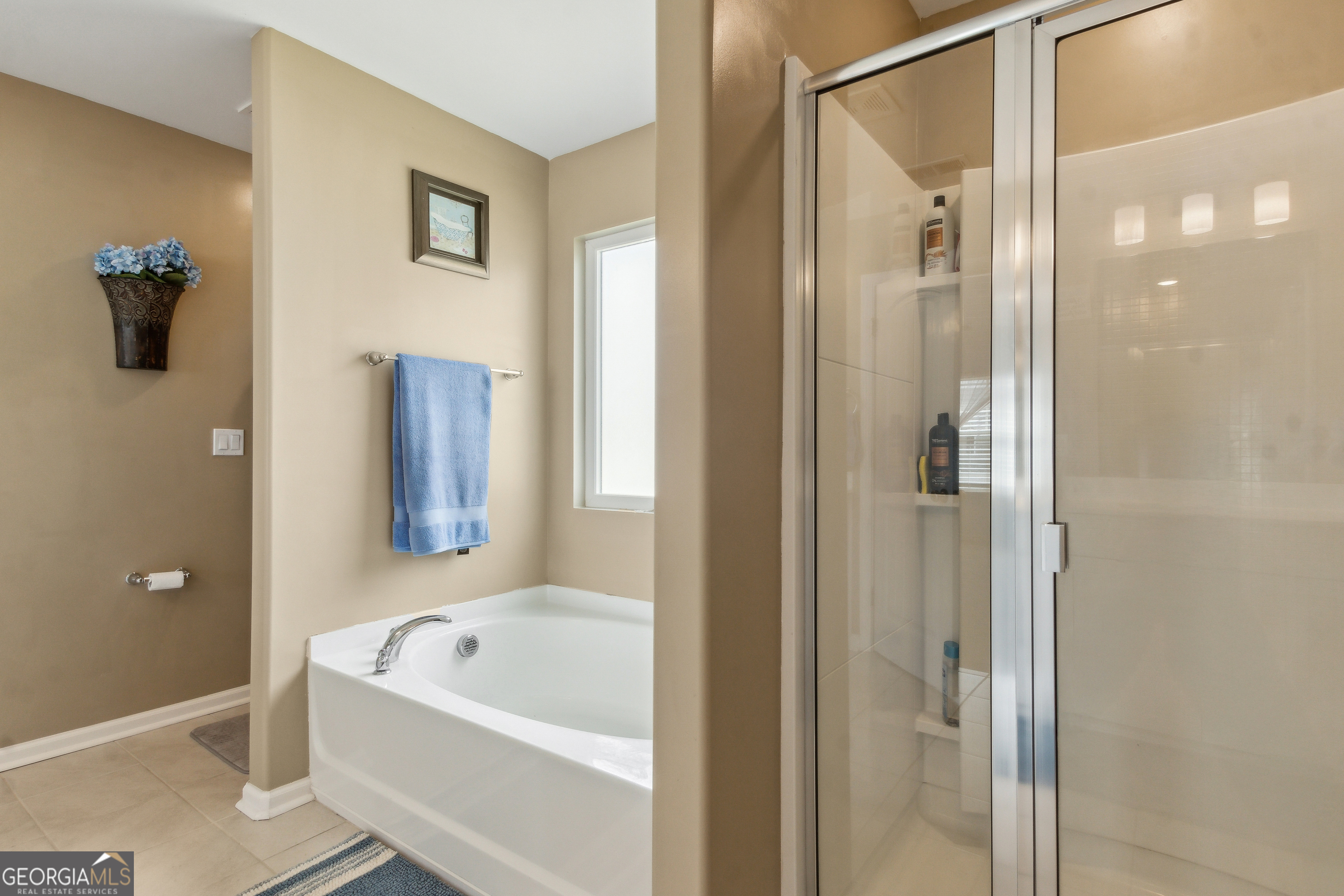 103 Olson Way Kingsland, GA 31548 - Photo 38 of 54 a bathroom with a tub a shower and a mirror
