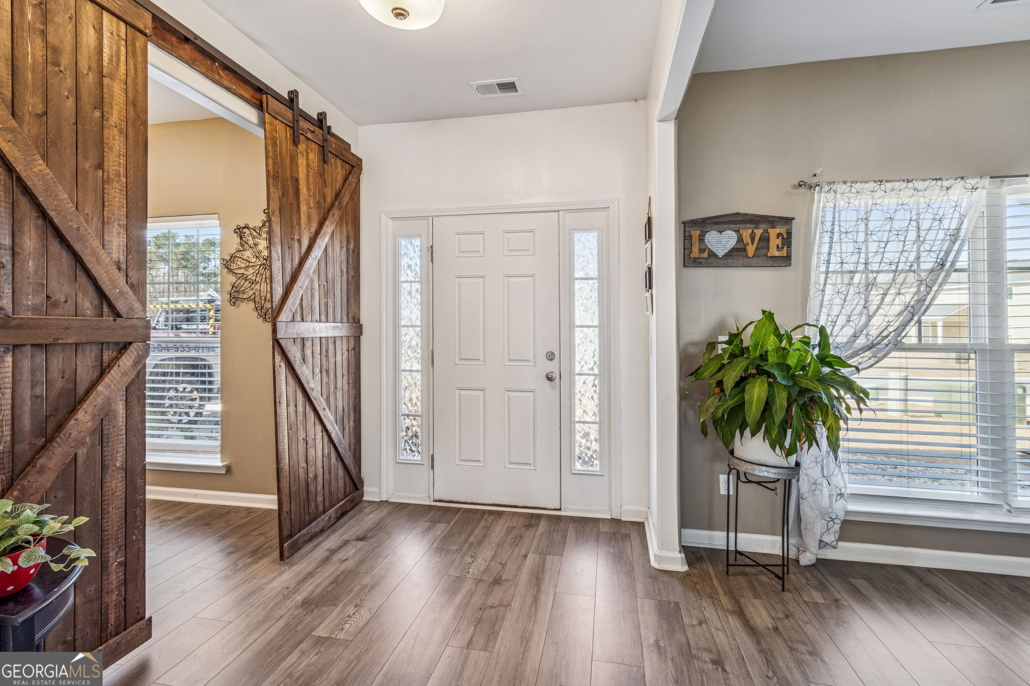 103 Olson Way Kingsland, GA 31548 - Photo 6 of 54 a view of an entryway with wooden floor and a potted plant