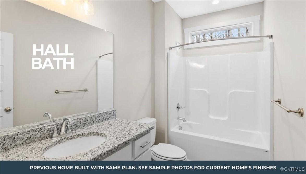 80 Maple Tree Lane Spring Grove, VA 23881 - Photo 9 of 14 a bathroom with a granite countertop sink a mirror and a bathtub