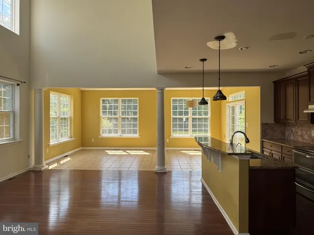 a room with lots of counter top space and wooden floor
