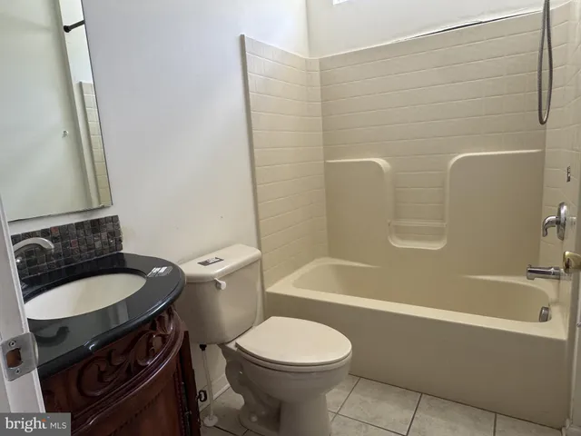 a bathroom with a sink a toilet and bathtub