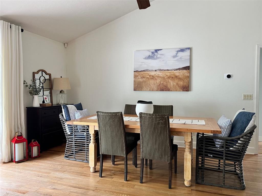 12595 Southeast Sunset Harbor Road Weirsdale, FL 32195 - Photo 4 of 25 a view of a dining room with furniture and wooden floor