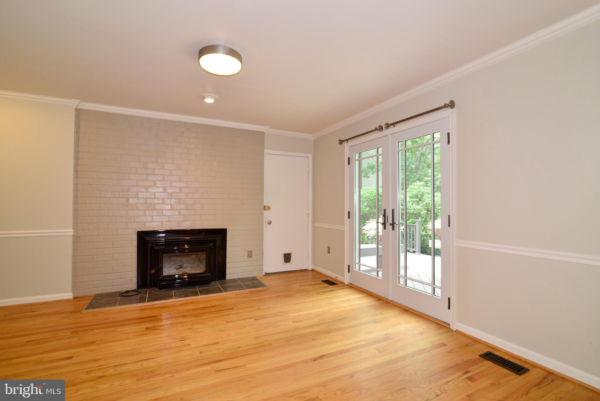 11480 Bingham Terrace Reston, VA 20191 - Photo 20 of 48 Family Room with fireplace and brick accent wall.