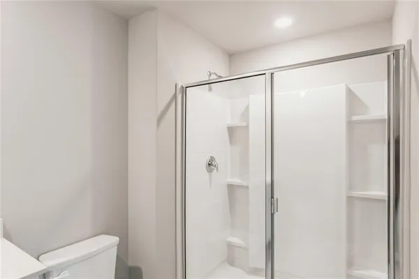 a bathroom with a glass shower door