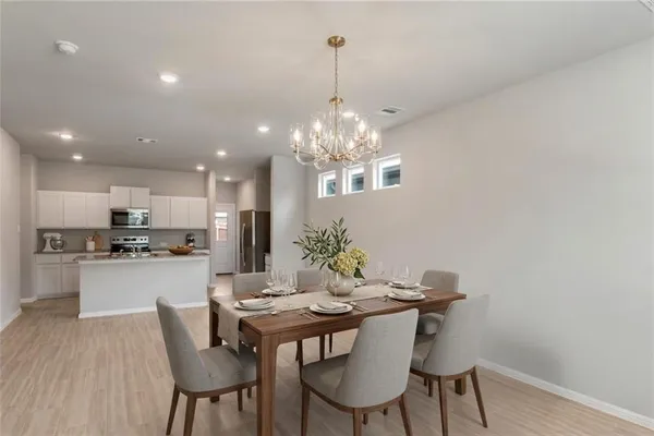 a kitchen with a table and chairs in it