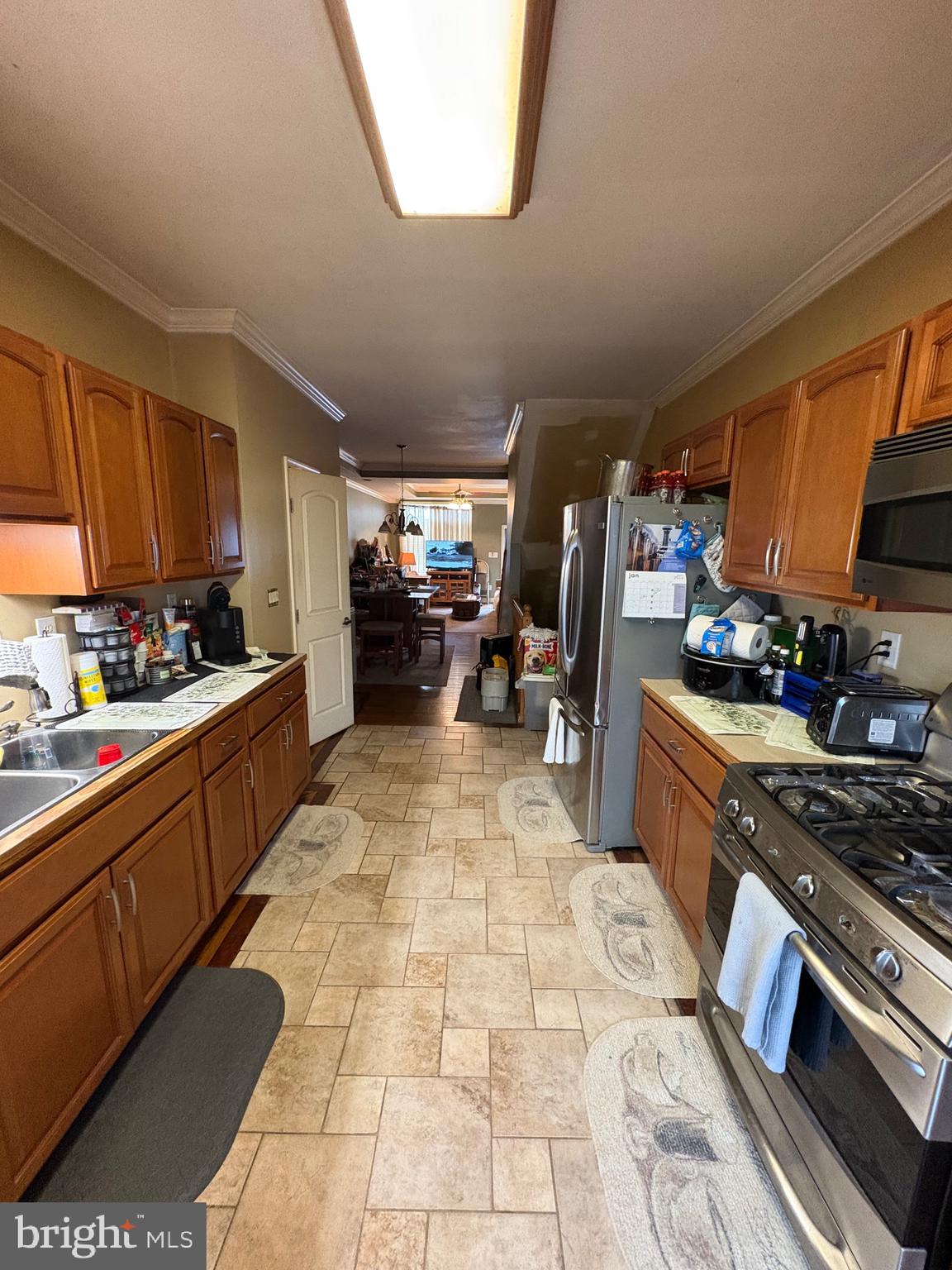 2713 Hampden Avenue Baltimore, MD 21211 - Photo 9 of 23 a large kitchen with stainless steel appliances and cabinets