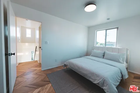 a bathroom with a bathtub shower sink vanity and mirror
