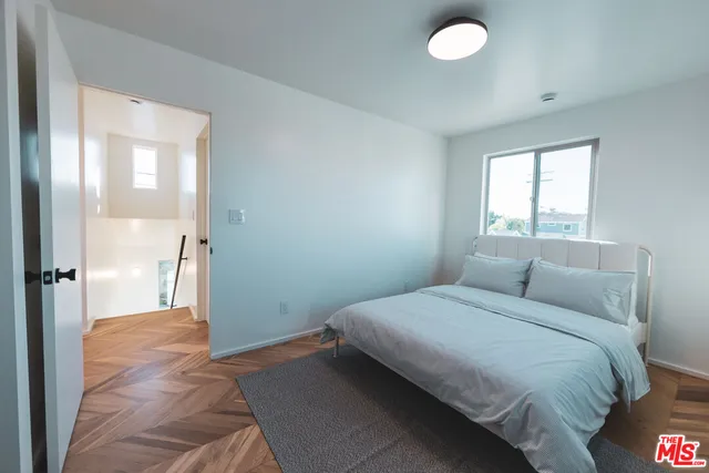 a bathroom with a bathtub shower sink vanity and mirror