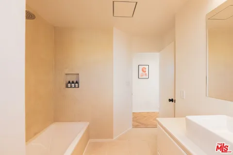 a bedroom with a bed and a lamp