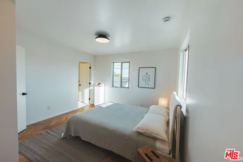 a bedroom with a bed and window