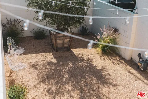 a view of a patio with a table and chairs