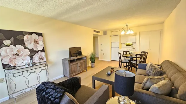 a living room with furniture a couch and a flat screen tv