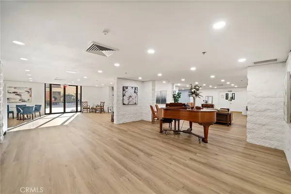 a living room with furniture a wooden floor and a large window