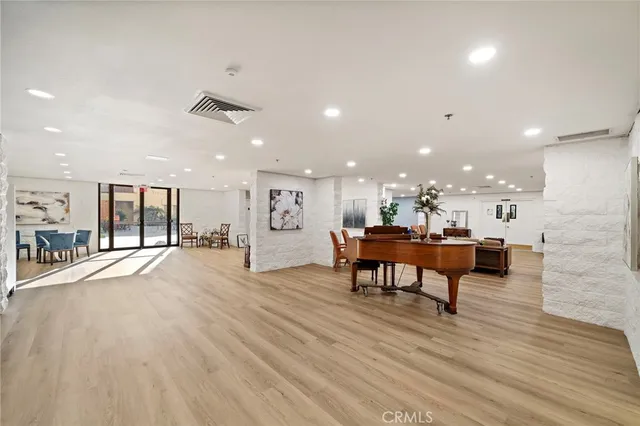 a living room with furniture and kitchen view