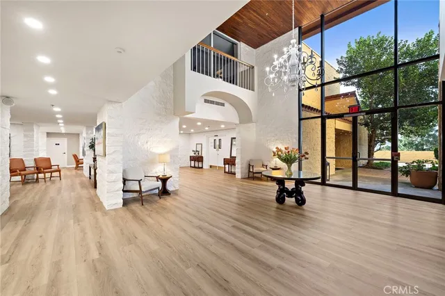 a living room with furniture a wooden floor and a large window