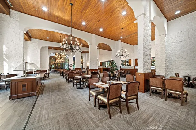 a very nice looking living room with chairs and kitchen view