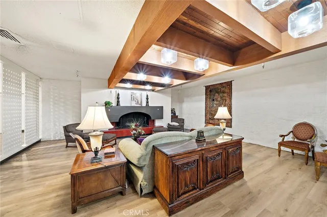 a living room with furniture a fireplace and a table