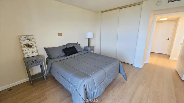 a bedroom with a bed and wooden floor