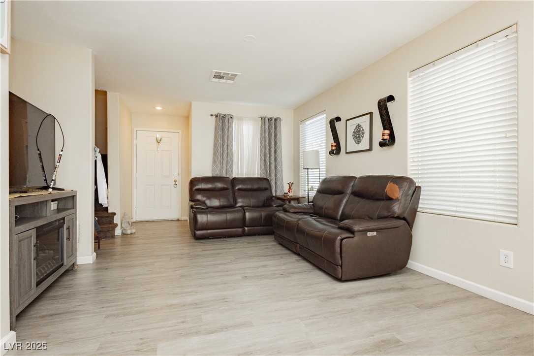 2082 Pillar Pointe Street Las Vegas, NV 89115 - Photo 4 of 18 Living room with light wood-style floors and stairway
