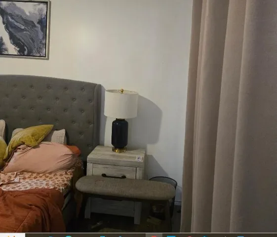 a living room with furniture and a painting on the wall