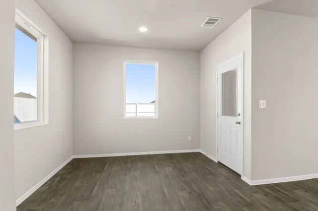 wooden floor in an empty room with a window
