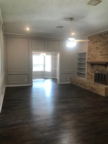 a view of a livingroom with wooden floor closet and window
