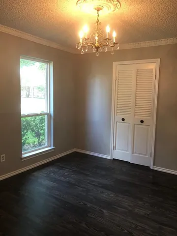 a view of a room with wooden floor