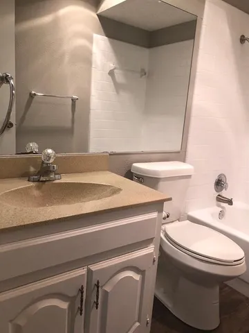 a bathroom with a sink a toilet and a mirror
