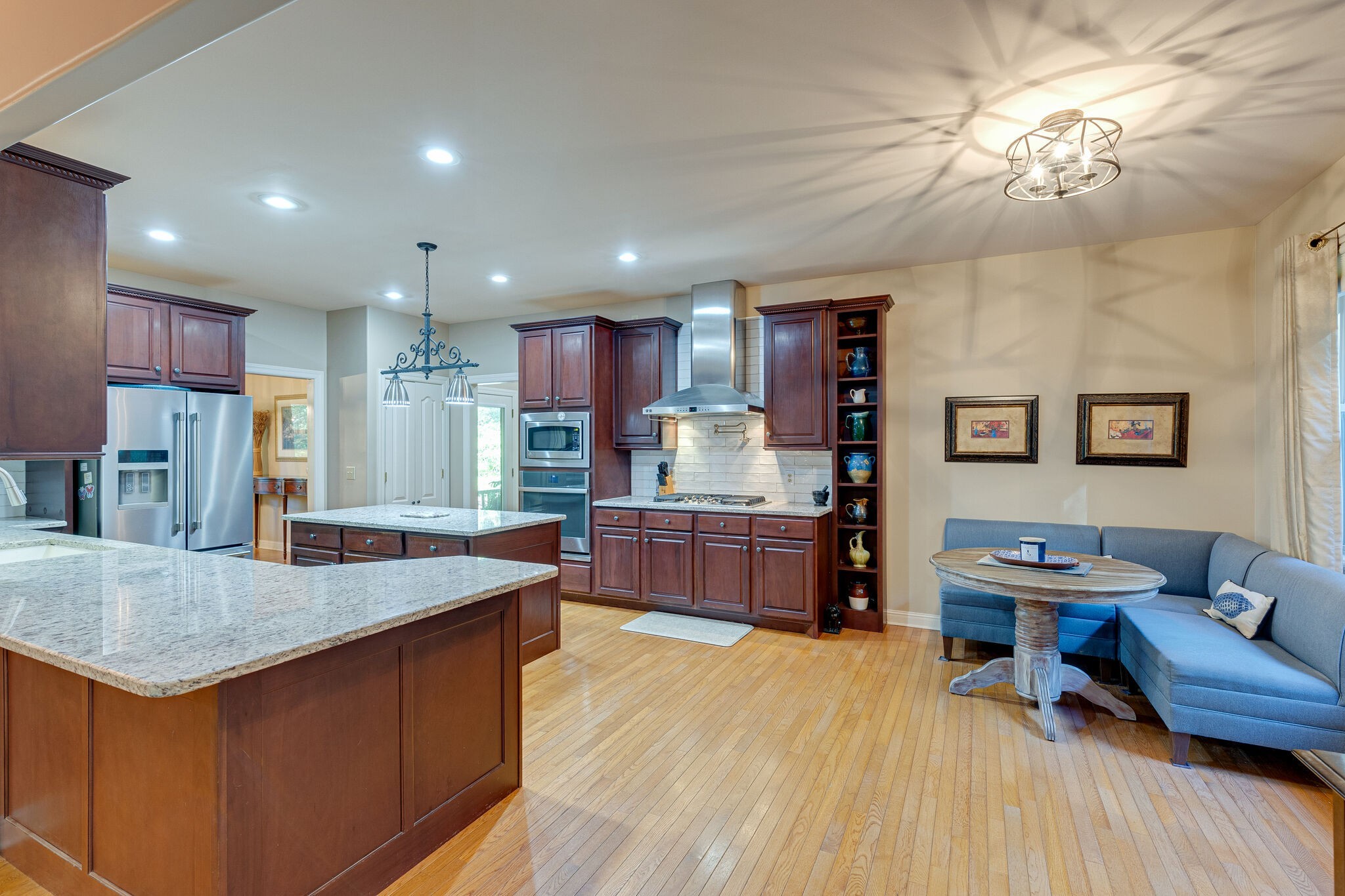 1457 Center Star Road Columbia, TN 38401 - Photo 18 of 45 a kitchen with stainless steel appliances granite countertop a sink dishwasher and a refrigerator with wooden floor