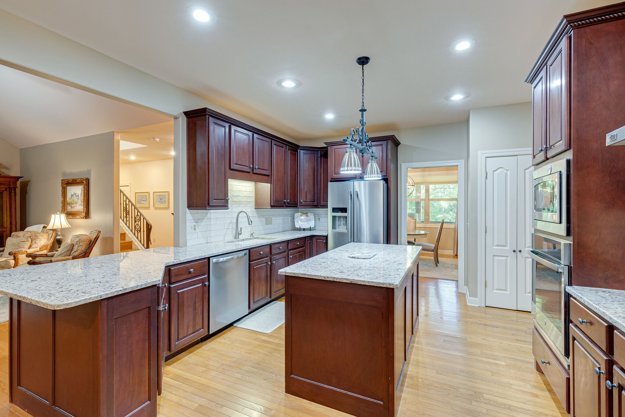 1457 Center Star Road Columbia, TN 38401 - Photo 22 of 45 a kitchen with stainless steel appliances granite countertop wooden cabinets a sink a stove a refrigerator and island