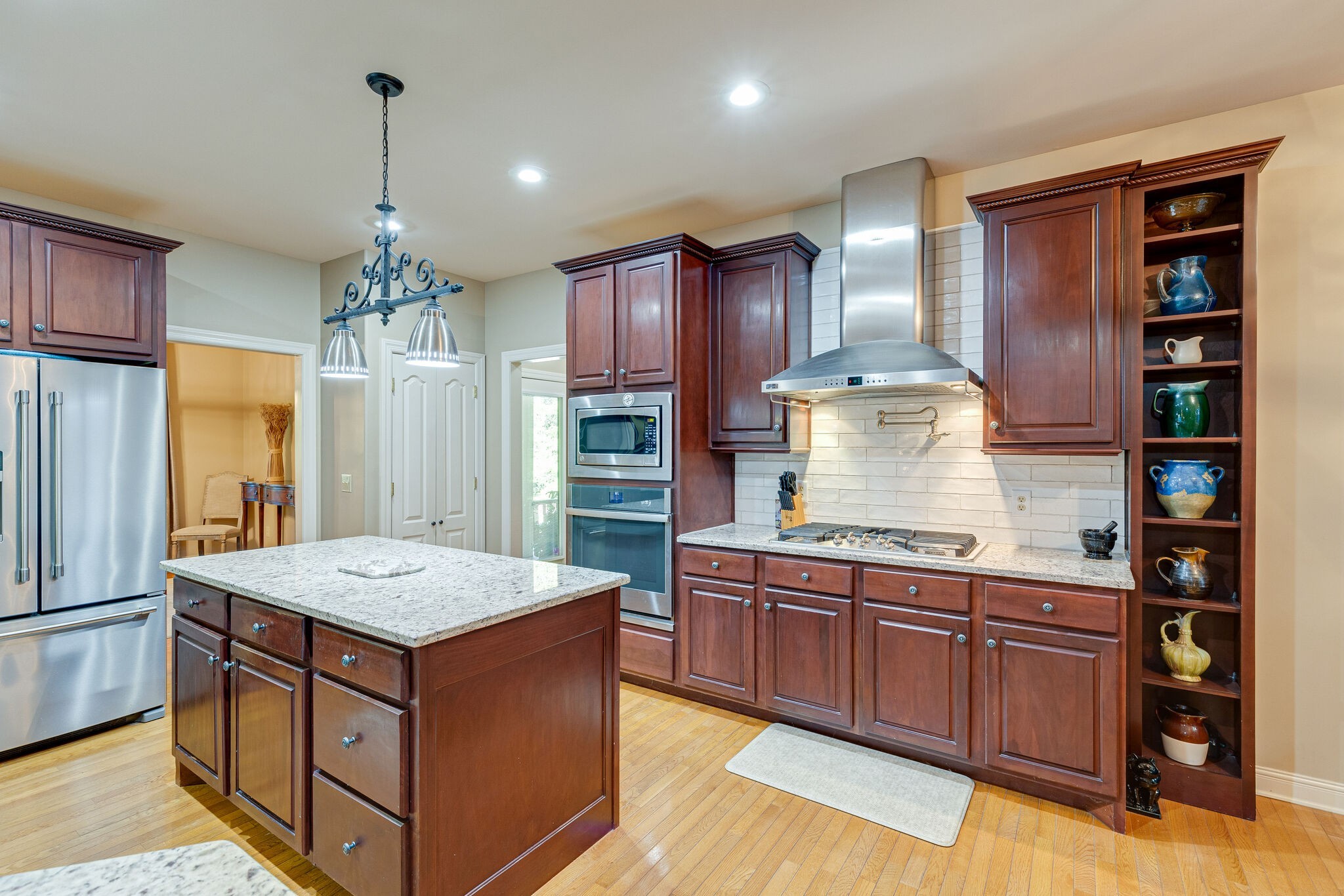 1457 Center Star Road Columbia, TN 38401 - Photo 23 of 45 a kitchen that has a lot of cabinets and wooden floor