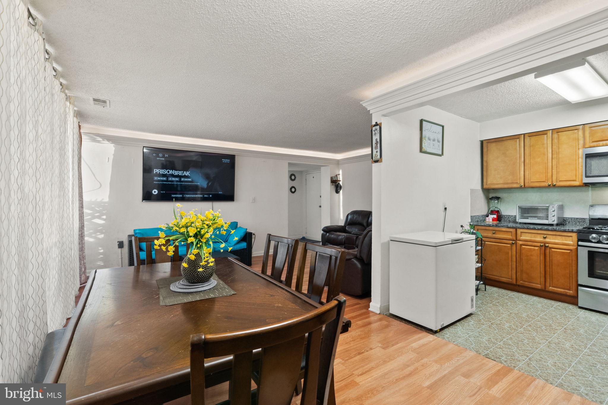 1832 Metzerott Road, Unit 303 Adelphi, MD 20783 - Photo 14 of 22 a view of a dining room with furniture and a kitchen